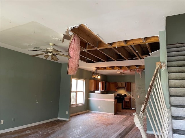 staircase with ceiling fan and wood-type flooring