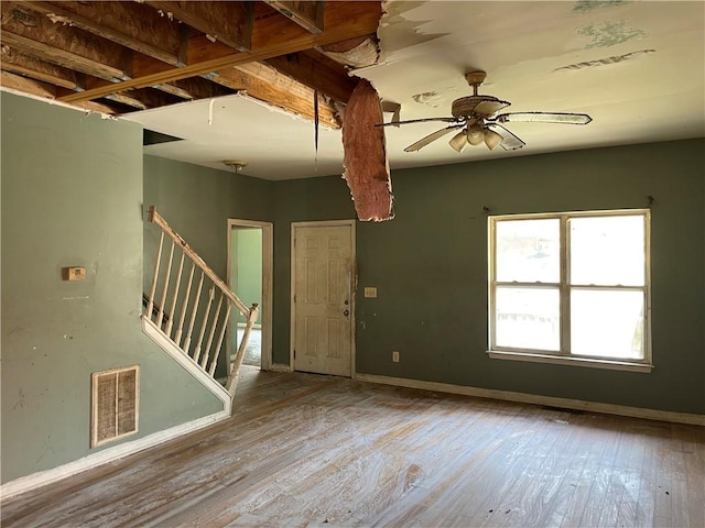 foyer entrance with ceiling fan and light hardwood / wood-style flooring