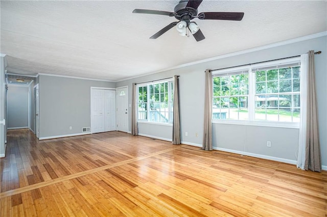 879 Rock Oak Ln, Lawrenceville, GA 30046 - empty room featuring light wood-style floors, crown molding, baseboards, ceiling fan, and a textured ceiling