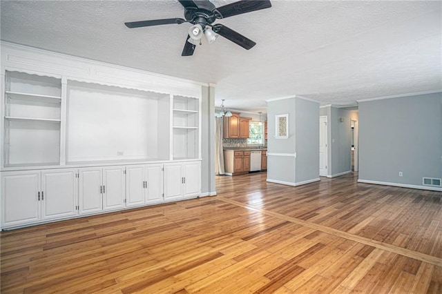 879 Rock Oak Ln, Lawrenceville, GA 30046 - unfurnished living room with a textured ceiling, light wood-style floors, a chandelier, ceiling fan, and baseboards