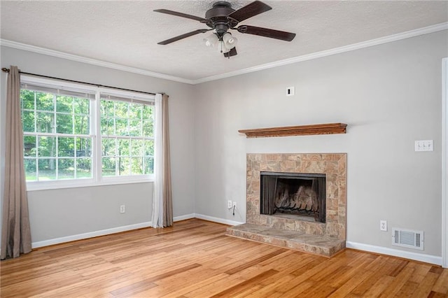 879 Rock Oak Ln, Lawrenceville, GA 30046 - unfurnished living room with wood finished floors, a textured ceiling, a ceiling fan, baseboards, and a fireplace with raised hearth