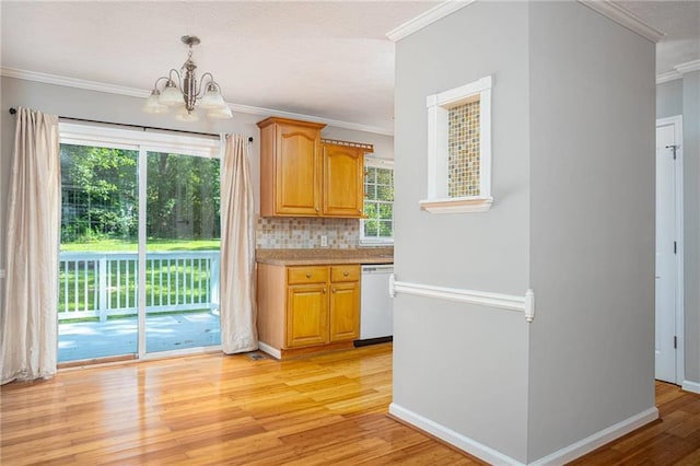 879 Rock Oak Ln, Lawrenceville, GA 30046 - kitchen with white dishwasher, a chandelier, light wood-style floors, crown molding, and plenty of natural light
