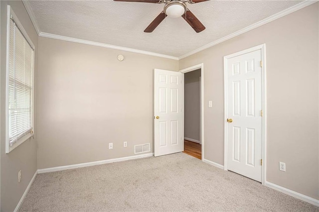 879 Rock Oak Ln, Lawrenceville, GA 30046 - unfurnished bedroom featuring carpet floors, baseboards, a textured ceiling, ornamental molding, and a ceiling fan
