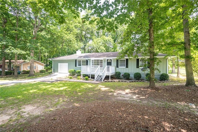 879 Rock Oak Ln, Lawrenceville, GA 30046 - single story home with asphalt driveway, a garage, a porch, a chimney, and board and batten siding