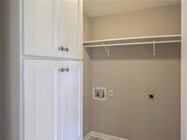879 Rock Oak Ln, Lawrenceville, GA 30046 - laundry room featuring electric dryer hookup, cabinet space, hookup for a washing machine, and baseboards