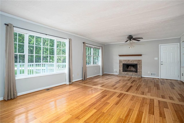 879 Rock Oak Ln, Lawrenceville, GA 30046 - unfurnished living room featuring a ceiling fan, light wood-style floors, baseboards, a textured ceiling, and crown molding