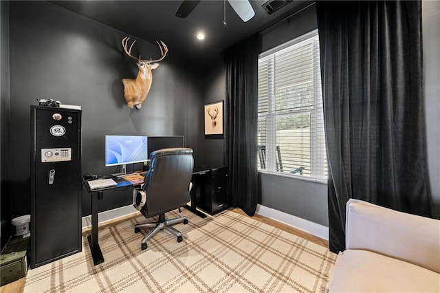 office featuring a ceiling fan and baseboards