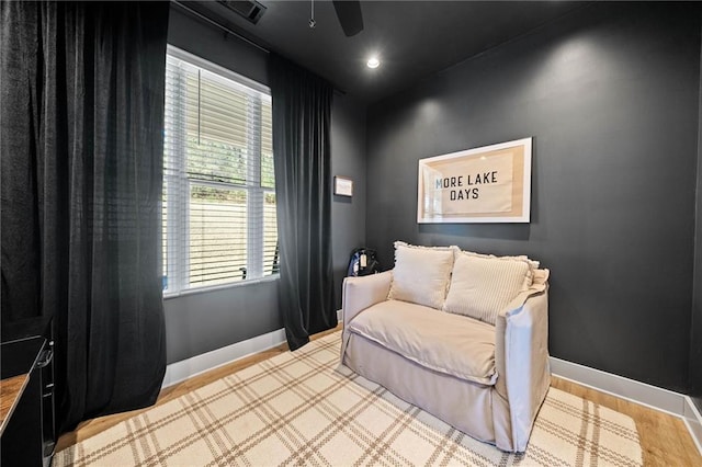 sitting room with visible vents and baseboards