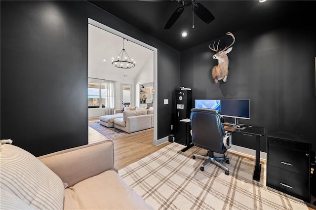 home office with ceiling fan with notable chandelier, baseboards, and wood finished floors