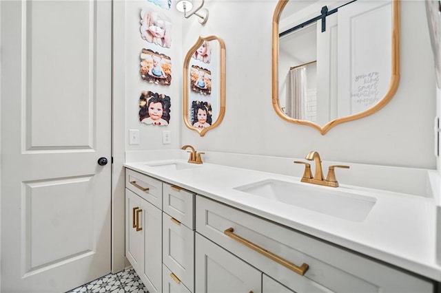 bathroom with a sink, double vanity, and tile patterned floors