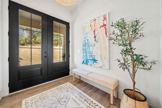 foyer with french doors and wood finished floors