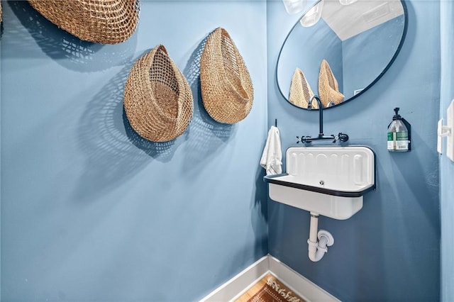 bathroom with a sink and baseboards