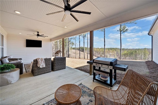 sunroom with wood ceiling and ceiling fan