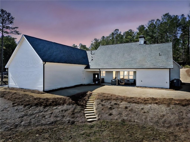 view of front of house featuring roof with shingles and stairs