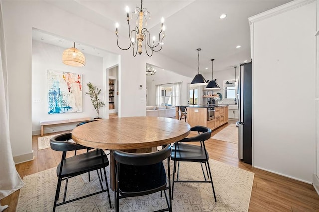 dining room featuring baseboards, recessed lighting, light wood-type flooring, and a chandelier