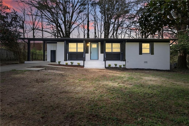 single story home with crawl space, a front yard, and a carport