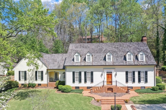 new england style home featuring a front lawn