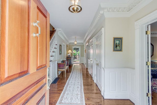 corridor featuring dark wood-type flooring and ornamental molding