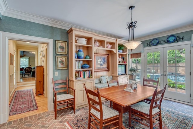 dining room featuring french doors and crown molding