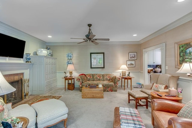 carpeted living room with ornamental molding and ceiling fan