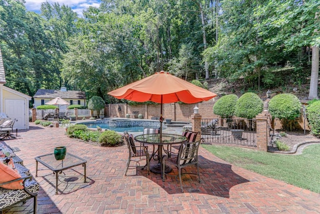 view of patio / terrace featuring a fenced in pool and a storage unit