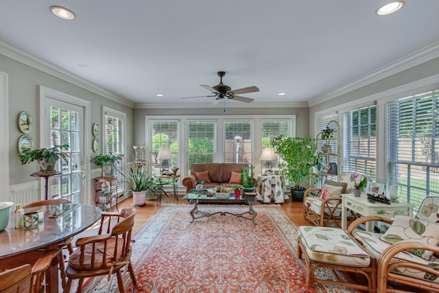 sunroom with a healthy amount of sunlight and ceiling fan