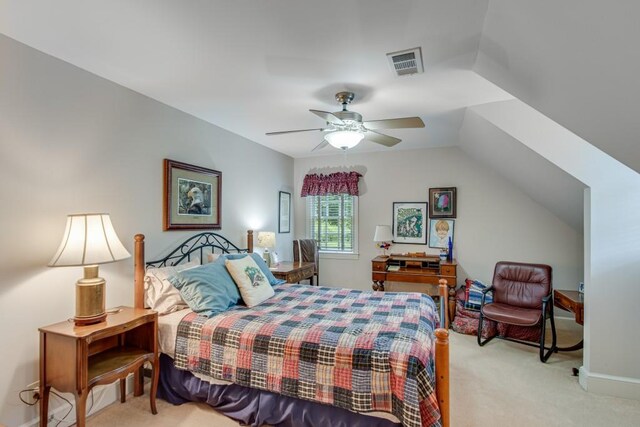 bedroom with vaulted ceiling, ceiling fan, and light carpet