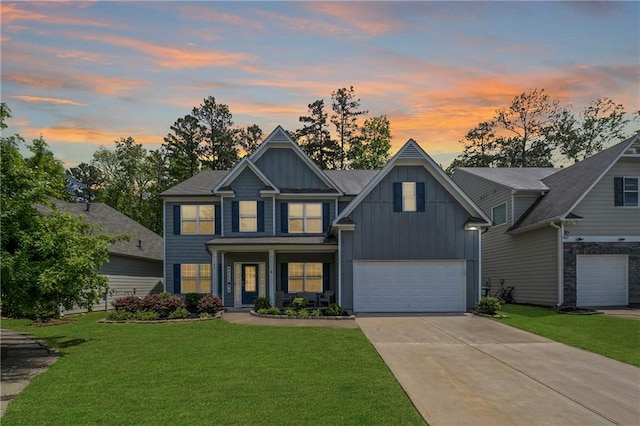 view of front of home featuring an attached garage, board and batten siding, driveway, and a front yard