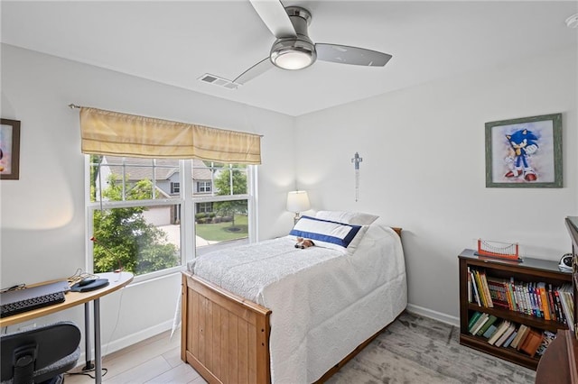 bedroom with baseboards, visible vents, multiple windows, and light wood-style floors