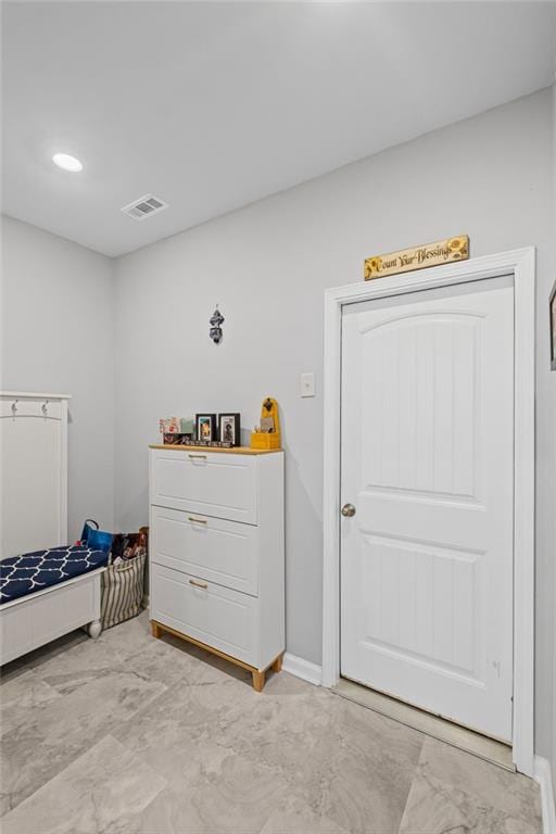 bedroom with visible vents, marble finish floor, and baseboards