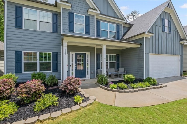 view of front of home with board and batten siding, covered porch, and concrete driveway