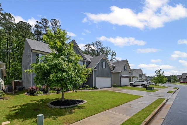 view of front of home with a garage, a front yard, board and batten siding, concrete driveway, and a residential view