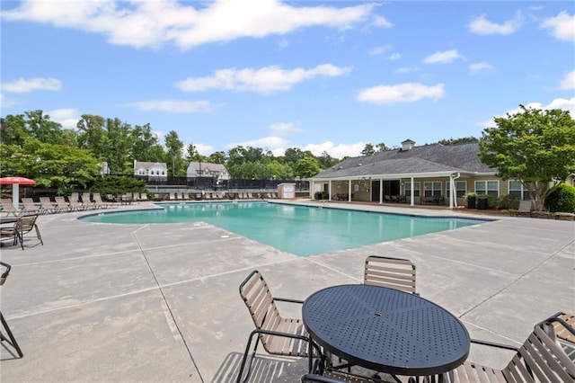 pool with fence and a patio area