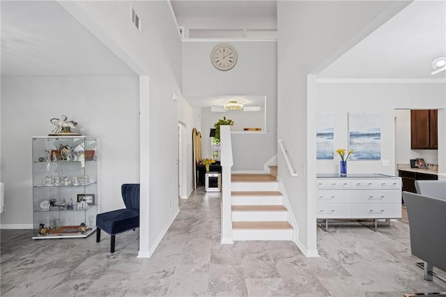 entrance foyer featuring visible vents, marble finish floor, stairs, and baseboards