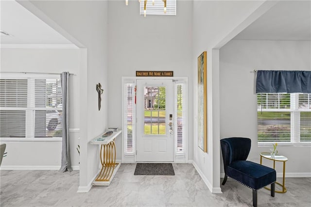 entryway with baseboards, marble finish floor, and a wealth of natural light