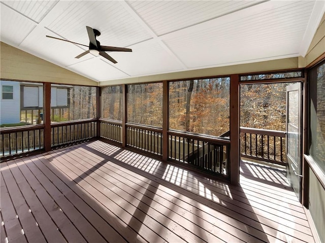 unfurnished sunroom with ceiling fan and vaulted ceiling