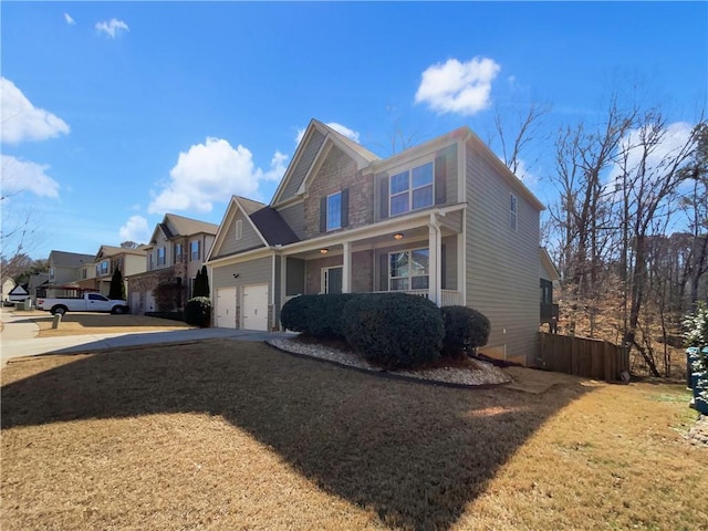 view of side of home featuring driveway, a yard, and a residential view