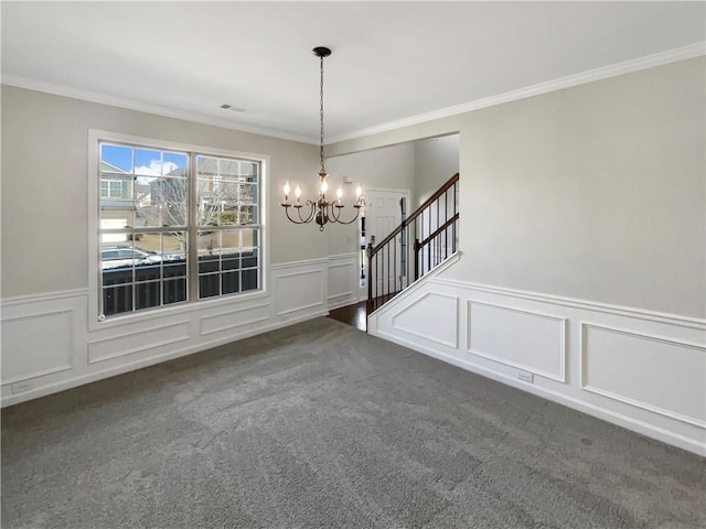 unfurnished dining area with visible vents, a wainscoted wall, stairway, dark colored carpet, and a notable chandelier