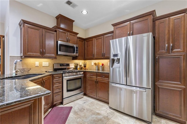 2905 Ivey Ridge Ln, Roswell, GA 30076 - kitchen featuring appliances with stainless steel finishes, dark stone countertops, tasteful backsplash, and recessed lighting