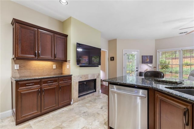 2905 Ivey Ridge Ln, Roswell, GA 30076 - kitchen with dishwasher, dark stone countertops, a tile fireplace, tasteful backsplash, and a ceiling fan