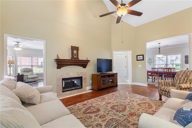 2905 Ivey Ridge Ln, Roswell, GA 30076 - living room with a ceiling fan, a towering ceiling, wood finished floors, a premium fireplace, and healthy amount of natural light