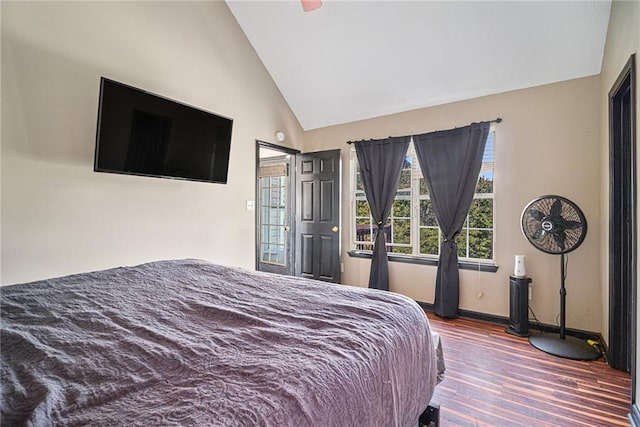 bedroom with wood-type flooring and high vaulted ceiling