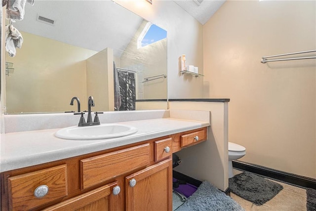 bathroom with vaulted ceiling, vanity, tile patterned flooring, a shower with shower curtain, and toilet