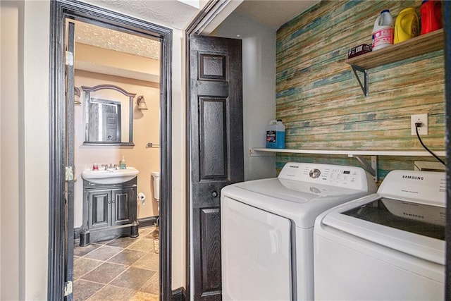 clothes washing area featuring sink and washing machine and dryer