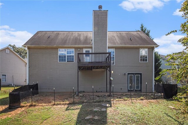 rear view of property with a yard