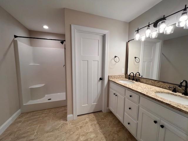 34 Great Works Dr, Dahlonega, GA 30533 - bathroom featuring double vanity, a shower, and baseboards