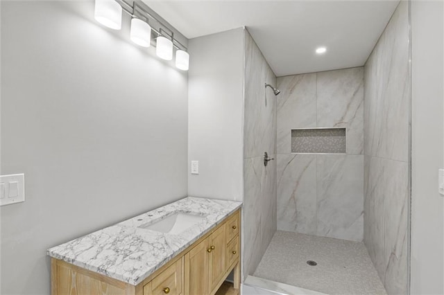 bathroom featuring vanity and tiled shower