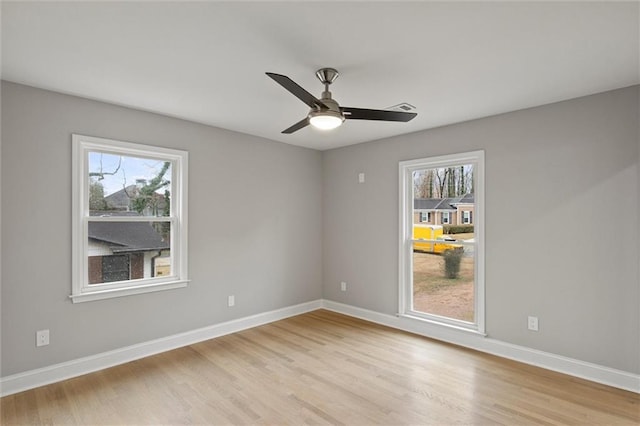 unfurnished room with light hardwood / wood-style floors, plenty of natural light, and ceiling fan