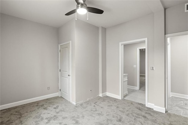 unfurnished bedroom with ensuite bath, ceiling fan, and light colored carpet