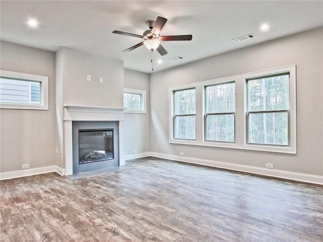 3305 Morgan Rd, Buford, GA 30519 - unfurnished living room with wood finished floors, ceiling fan, a glass covered fireplace, baseboards, and recessed lighting